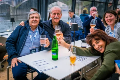 International corporate guests enjoying drinks together in Prague, illustrating the relaxed and inclusive atmosphere of MICE Prague events