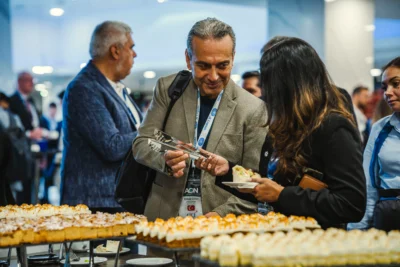Corporate guests networking over informal catering at a conference in Prague, showing how MICE Prague blends formality with relaxed atmosphere