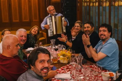 Corporate group enjoying a traditional dinner with live music in Prague, highlighting the social and cultural side of MICE Prague experiences