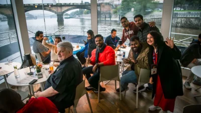 International corporate group enjoying a relaxed river cruise in Prague, highlighting the social and inclusive side of a MICE Prague experience